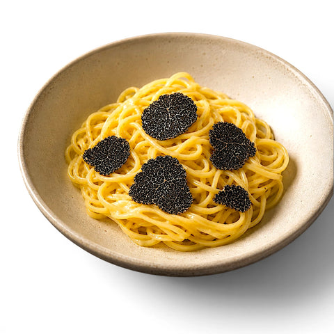 Fresh Tuber melanosporum slices served over warm tagliolini