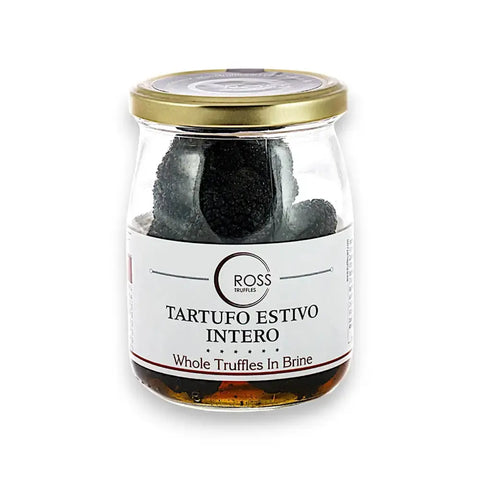Glass jar of black truffles in brine with a gold lid for Tuber Aestivum product